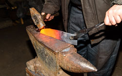 Forging molten metal.